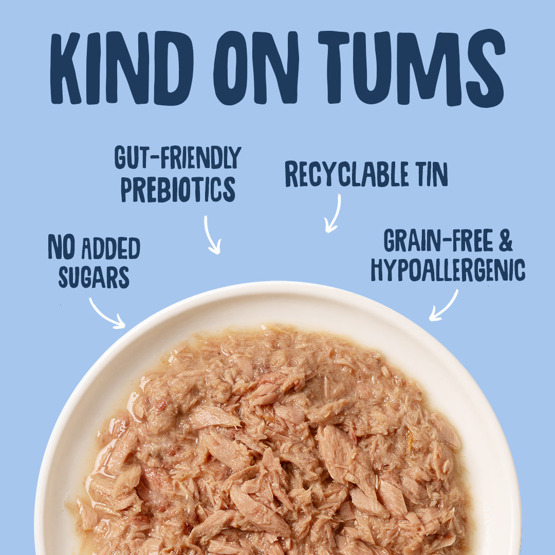 Bowl of pet food with 'Kind on Tums' text highlighting features like gut-friendly prebiotics, recyclable tin, no added sugars, grain-free, and hypoallergenic.